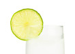 Glass of ice-cold water with slice of lime on white