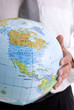 Businessman is holding an Earth in his hands