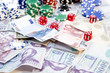 Poker hands - cards have focus with poker chips and money