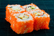Sushi with chopsticks shot on black