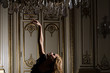 Woman dancing beneath chandelier