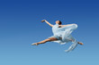 Dancer jumpimp against blue sky
