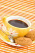 Cookies and cup with cofee on bamboo table-cloth