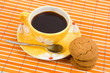 Cookies and cup with cofee on bamboo table-cloth