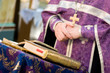 crossed hands of the praying priest