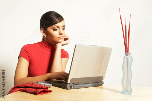 Photo: business woman with laptop and phone business woman with laptop and phone