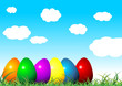 Easter eggs on grass with different colors over cloudy sky Easter eggs on grass with different colors over cloudy sky