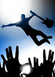 Music star jumping with the guitar in a concert
