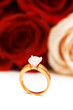Engagement ring and roses at the background
