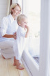Toddler and mum looking out a window