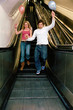 Couple with balloons on escalator