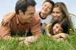 Family lying on meadow