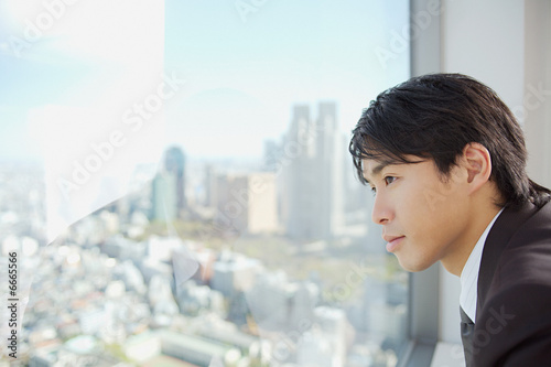 Businessman looking through window