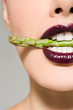Woman with asparagus in her mouth