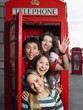 Tourists in a red telephone booth