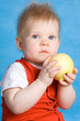 Baby boy eating an apple