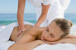 young woman having back massaged