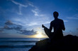 Shilouette of man meditating on the beach