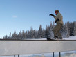 Photo: Snowboarder sliding on rail. Snowboarder sliding on rail.