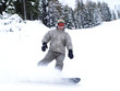 Photo: Snowboarder guy sliding on the slope. Snowboarder guy sliding on the slope.