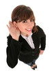 Businesswoman with hand to ear listening