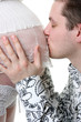Expectant father kissing pregnant wife's tummy