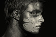 Portrait of young boy with artistic bodypaint drawing on face 