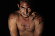latin young male with intense look and bodypaint drawing