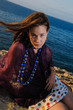 Portrait of young fashion model by the sea