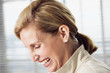 Business woman laughing.