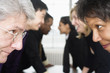 Close up of executives looking at each other.
