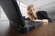 A business woman relaxing in front of a laptop.