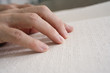 Close up of fingers on Braille.