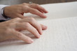 Close up of fingers on Braille.