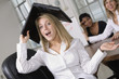 Portrait of a business woman with a laptop over her head.