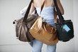 Foto: Rear view of a woman carrying bags. Rear view of a woman carrying bags.