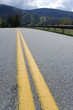 Close up of yellow divider lines on a highway.
