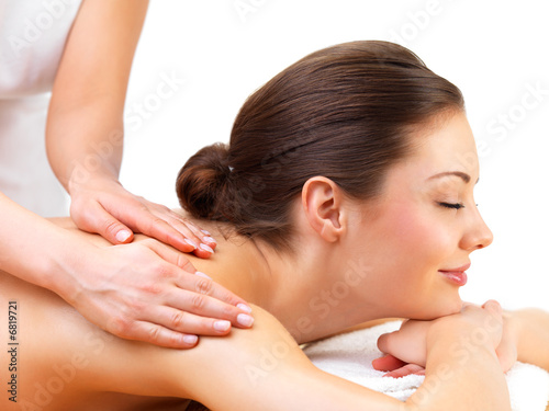 Foto: Young woman getting massage from female hands Young woman getting massage from female hands