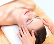 Young beautiful woman getting facial treatment
