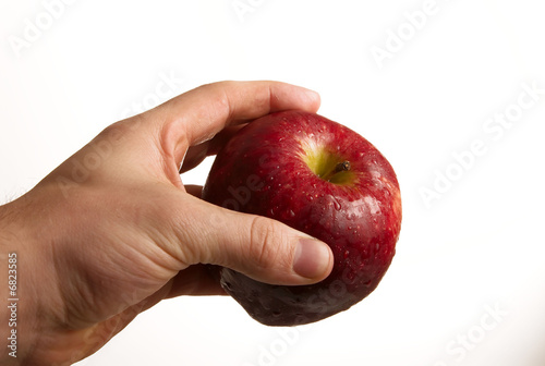 Photo: Hand holding apple on white background Hand holding apple on white background