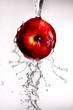 water pouring over apple on white