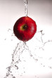 water pouring over red apple