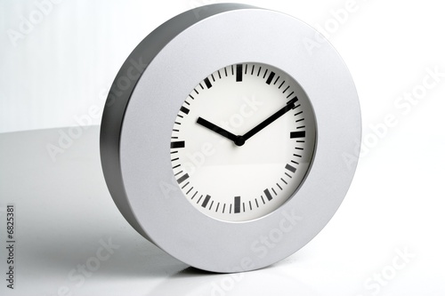 Photo: Modern silve wall clock on a white background Modern silve wall clock on a white background
