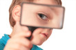 child looks through magnifier