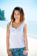 young woman smiles by the beach