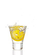 Lemon splashing into martini glass