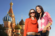 Two young women next to Saint Basil's Cathedral in Moscow