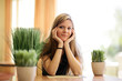 Beautiful young woman relaxing in healthy spa cafe.