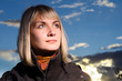 Beautiful blond girl over blue sky at sunset