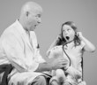 Doctor Letting Girl Listen to Toy Bear's Heart